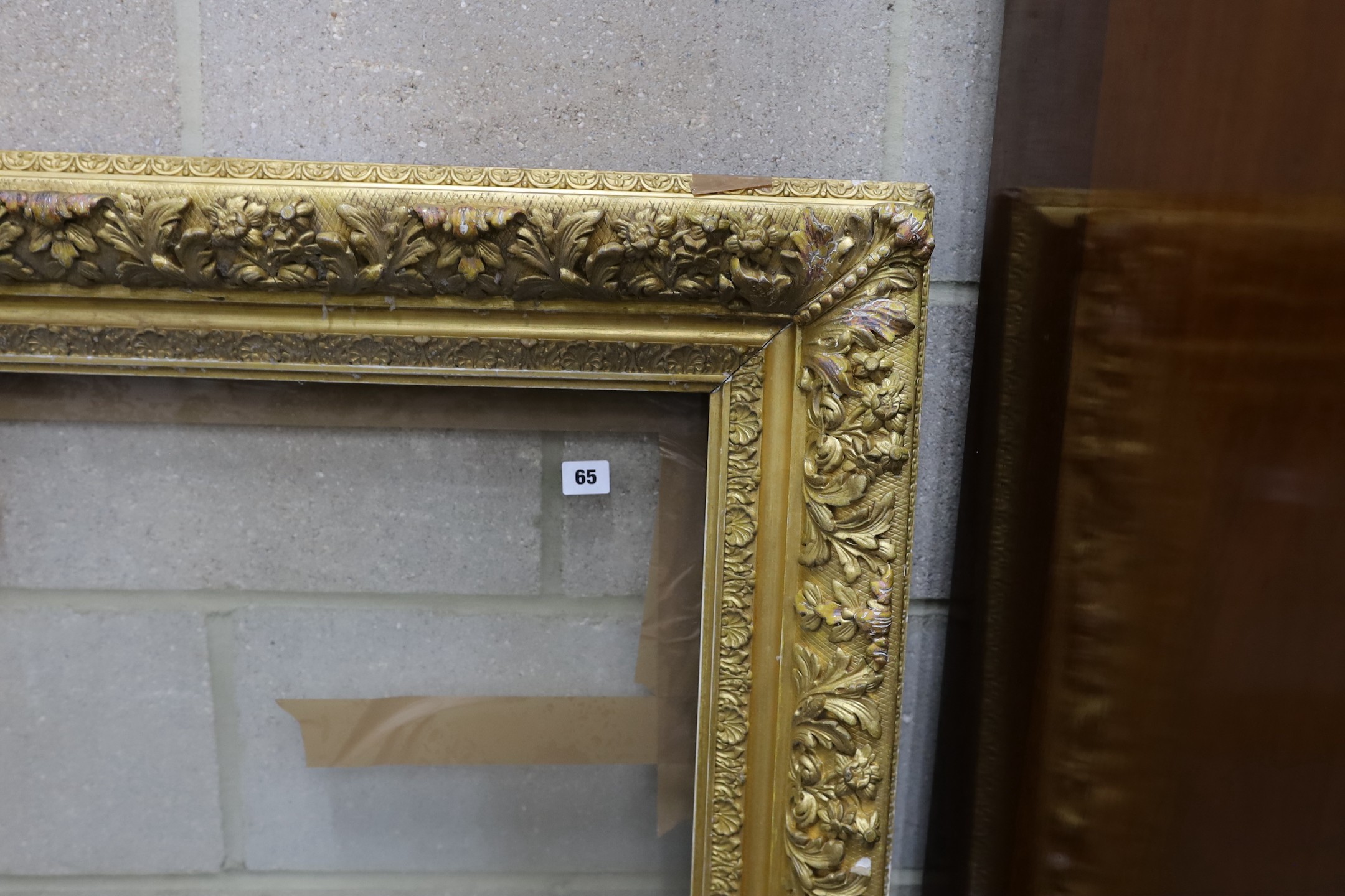 A Victorian rectangular giltwood and gesso picture frame, aperture 75 x 96 cms.